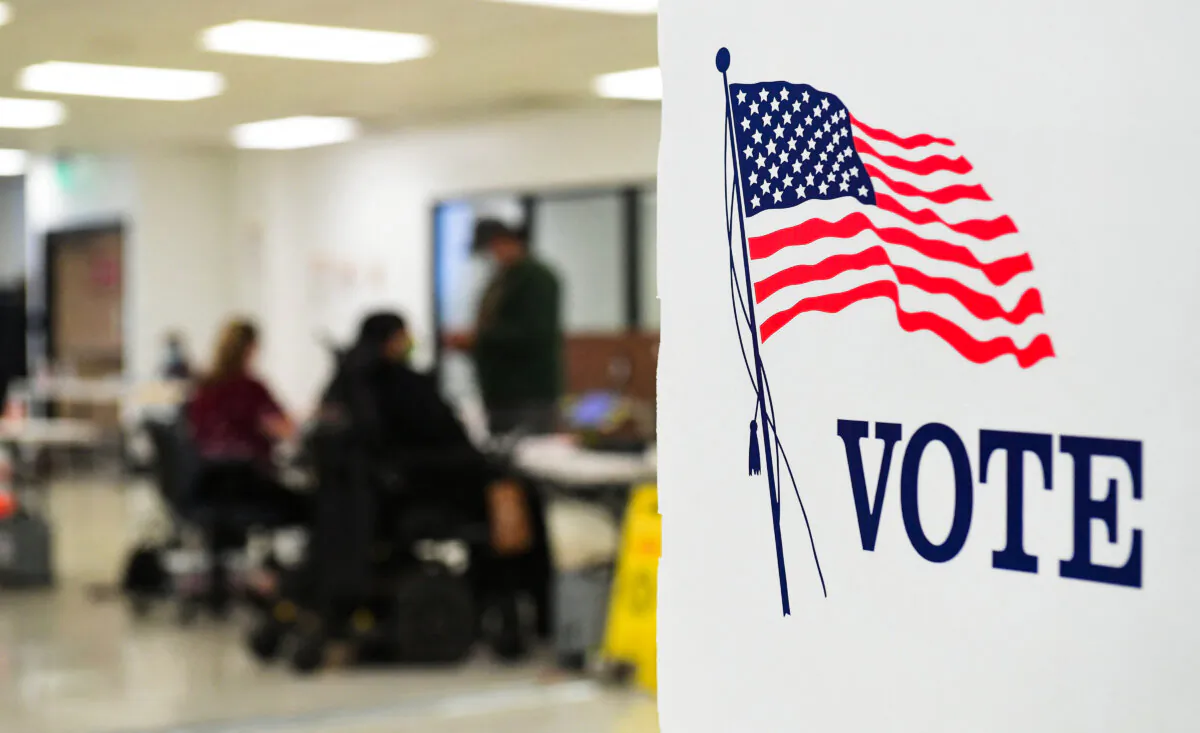 People check in before casting their vote at the Los Angeles County Registrar's Office in Norwalk, Calif., on Sept. 14, 2021. (Frederic J. Brown/AFP via Getty Images)