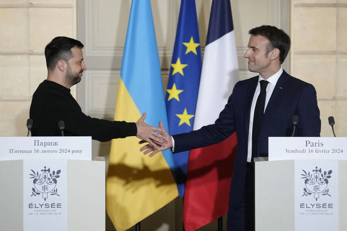 France's President Emmanuel Macron (R) shakes hands with Ukraine's President Volodymyr Zelenskyy (L) during a press conference at the Élysée Palace in Paris, on Feb. 16, 2024. (Thibault Camus/Pool/AFP via Getty Images)