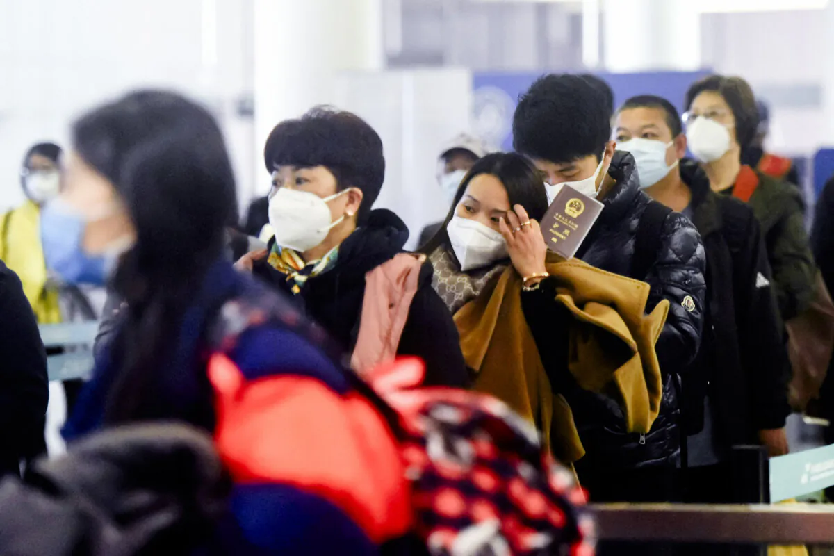 Passengers line up to pass through customs after arriving at Hangzhou Xiaoshan International Airport in China's eastern Zhejiang Province on Jan. 8, 2023. (STR/AFP via Getty Images)