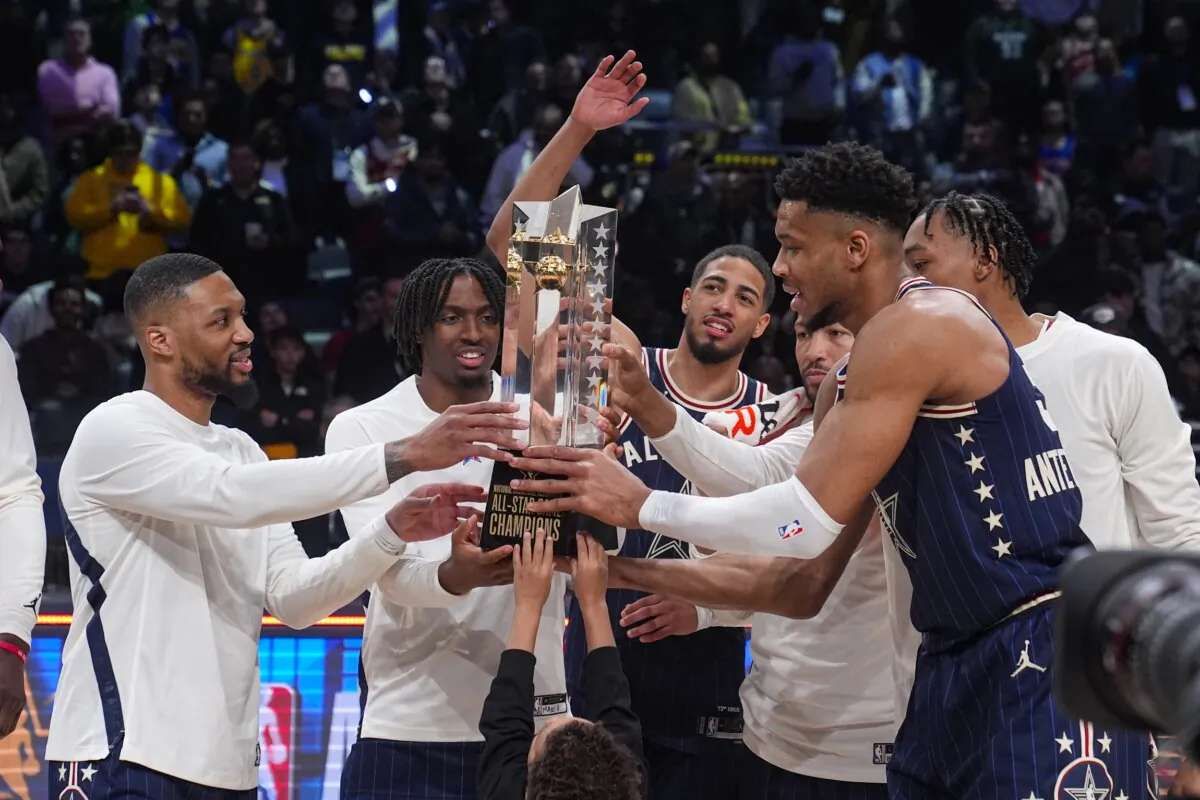 The East team, lead by captain Milwaukee Bucks forward Giannis Antetokounmpo (R), hoists the trophy after defeating the West 211-186 in the NBA All-Star basketball game in Indianapolis on Feb. 18, 2024. (Darron Cummings/AP Photo)