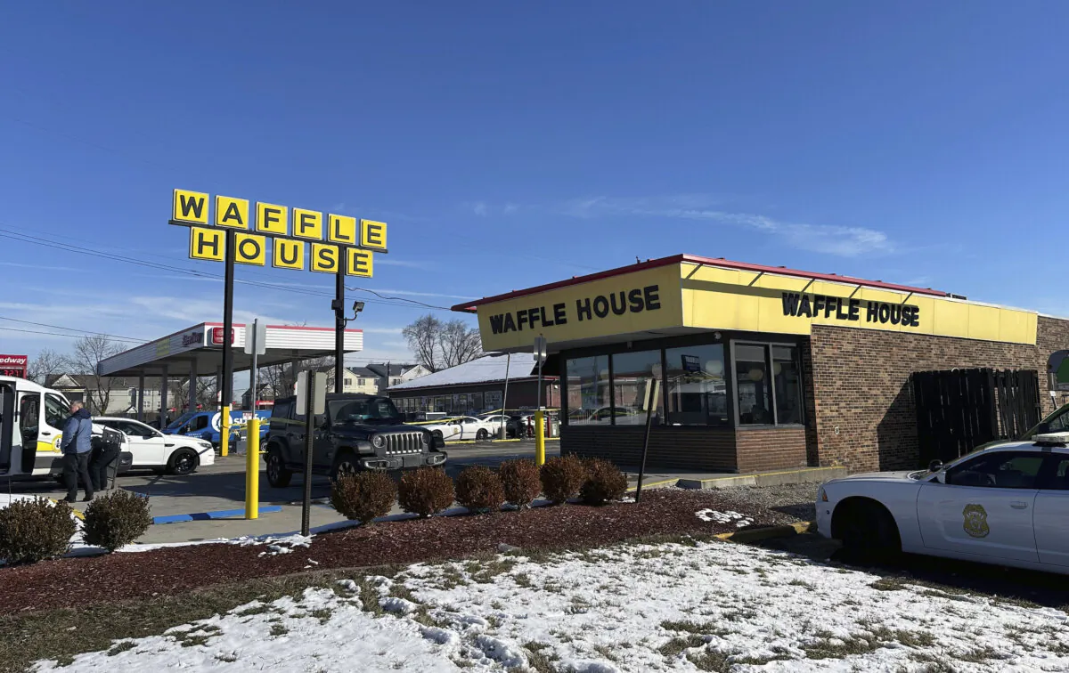 Police cars near a Waffle House in Indianapolis on Feb. 19, 2024, where at least one person was killed and several injured. (Isabella Volmert/AP Photo)
