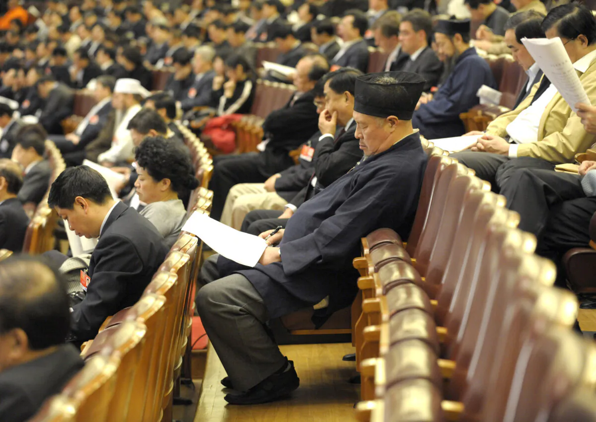 A Taoist delegate (C) takes a nap during the annual session of the National People's Congress (NPC) in Beijing on March 10, 2009. (Liu Jin/AFP via Getty Images)