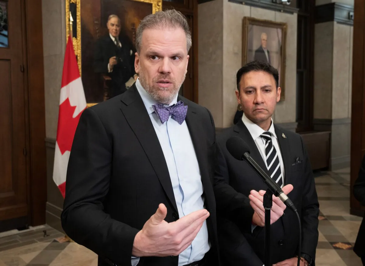 Minister of Justice and Attorney General of Canada Arif Virani (R) looks on as Health Minister Mark Holland speaks about assisted dying legislation in Ottawa on Feb. 1, 2024. (The Canadian Press/Adrian Wyld)