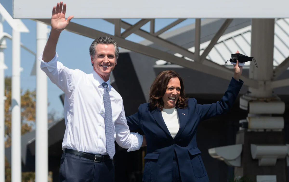 US Vice President Kamala Harris (R) waves alongside California Governor Gavin Newsom during a campaign event in San Leandro, California, on September 8, 2021. (Saul Loeb/AFP via Getty Images)