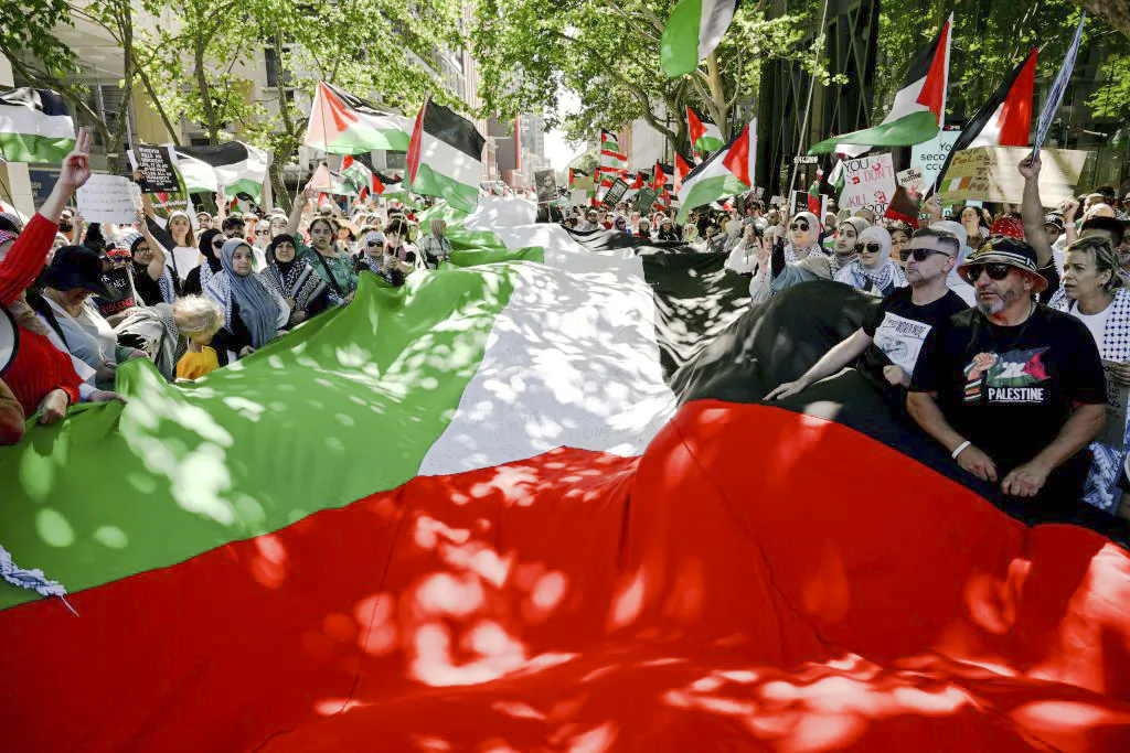 People march with flags and placards during a rally in support of the Palestinian people in Sydney on November 19, 2023. Thousands of civilians, both Palestinians and Israelis, have died since October 7, 2023, after Palestinian Hamas militants based in the Gaza Strip entered southern Israel in an unprecedented attack triggering a war declared by Israel on Hamas with retaliatory bombings on Gaza. (Photo by Saeed Khan / AFP) (Photo by SAEED KHAN/AFP via Getty Images)
