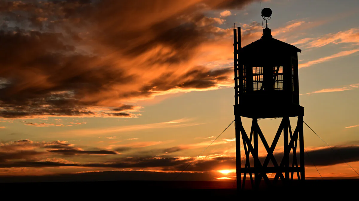 The sun sets behind a replica of the old guard tower at The Amache National Historic Site on Nov. 14, 2022, in Granada, Colorado. (Helen H. Richardson/The Denver Post/TNS)