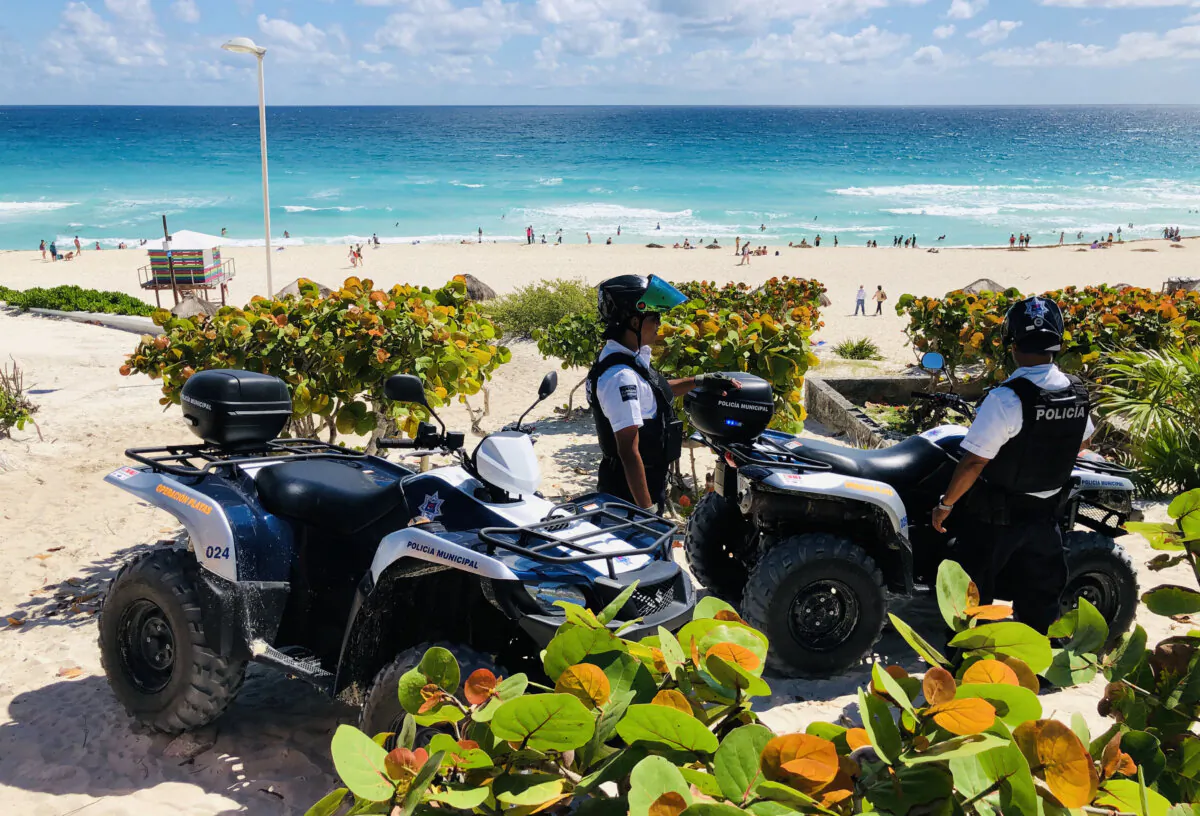 Police officers with quads stand guard on the beach in Cancun, Quintana Roo State, Mexico, on Feb. 16, 2019. (Daniel Slim/AFP via Getty Images)