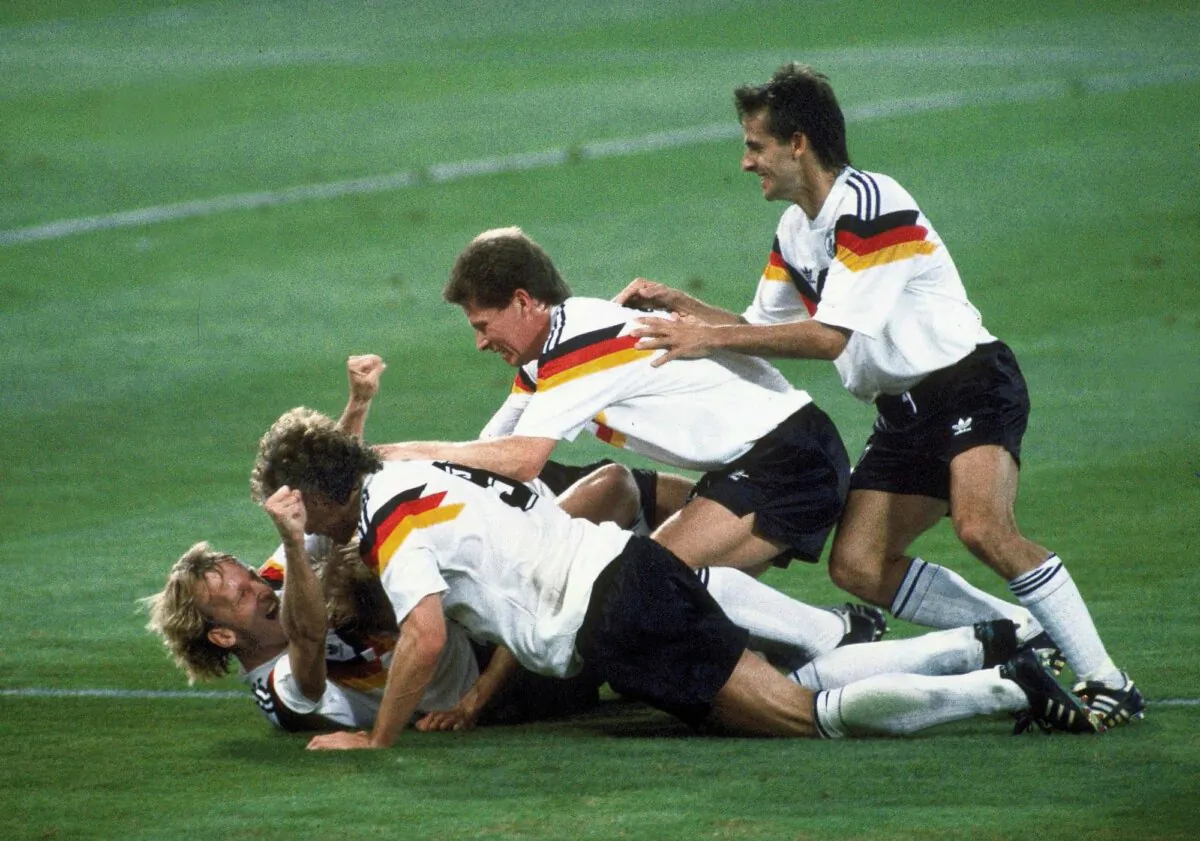 Germany players celebrate after Andreas Brehme, (L) on ground, scores the winning goal in the World Cup soccer final match against Argentina, in the Olympic Stadium, in Rome, on July 8, 1990. (Carlo Fumagalli/AP Photo)