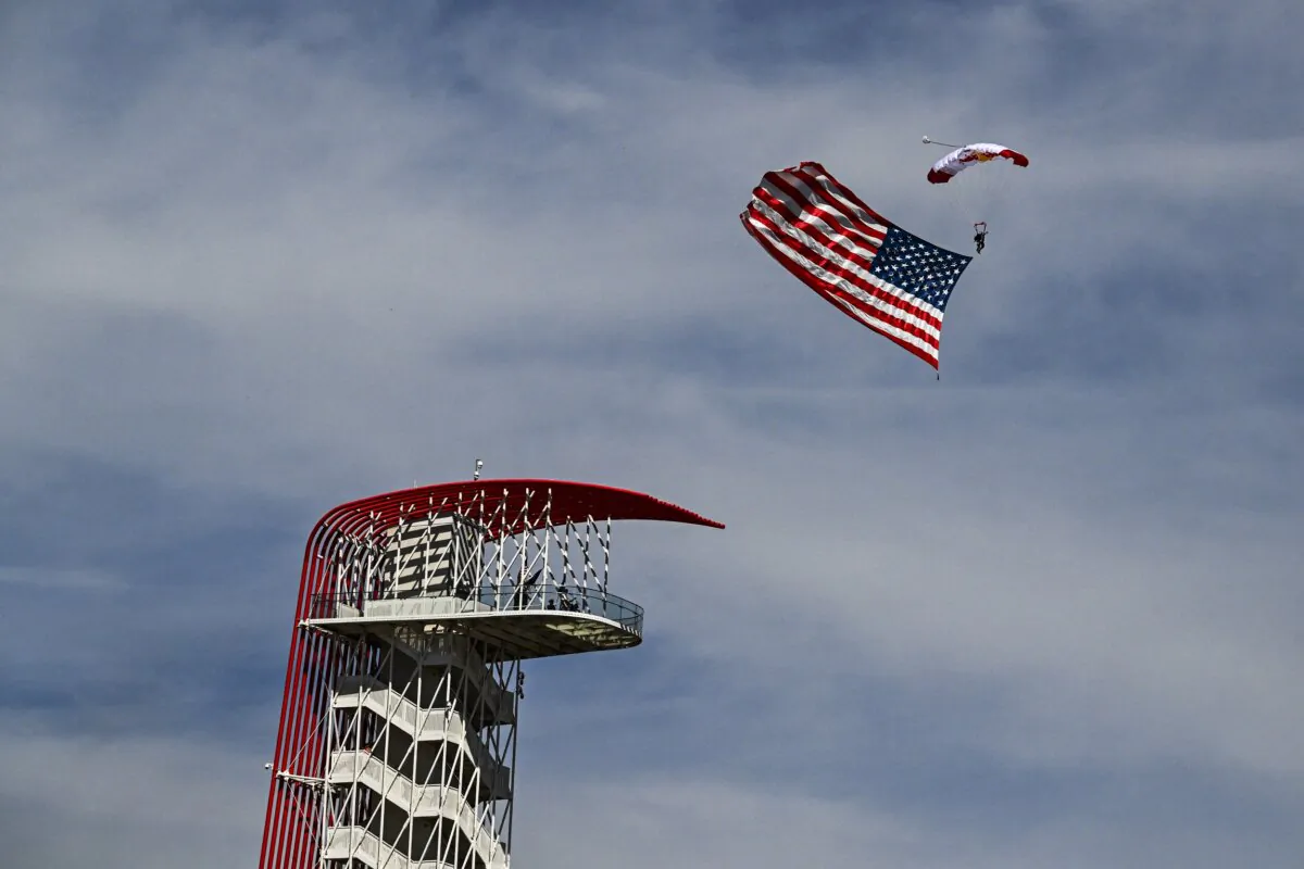 A parachute jumper with a U.S. flag before the start of the 2023 U.S. Formula One Grand Prix at the Circuit of the Americas in Austin, Texas, on Oct. 22, 2023. (Chandan Khanna/AFP via Getty Images)