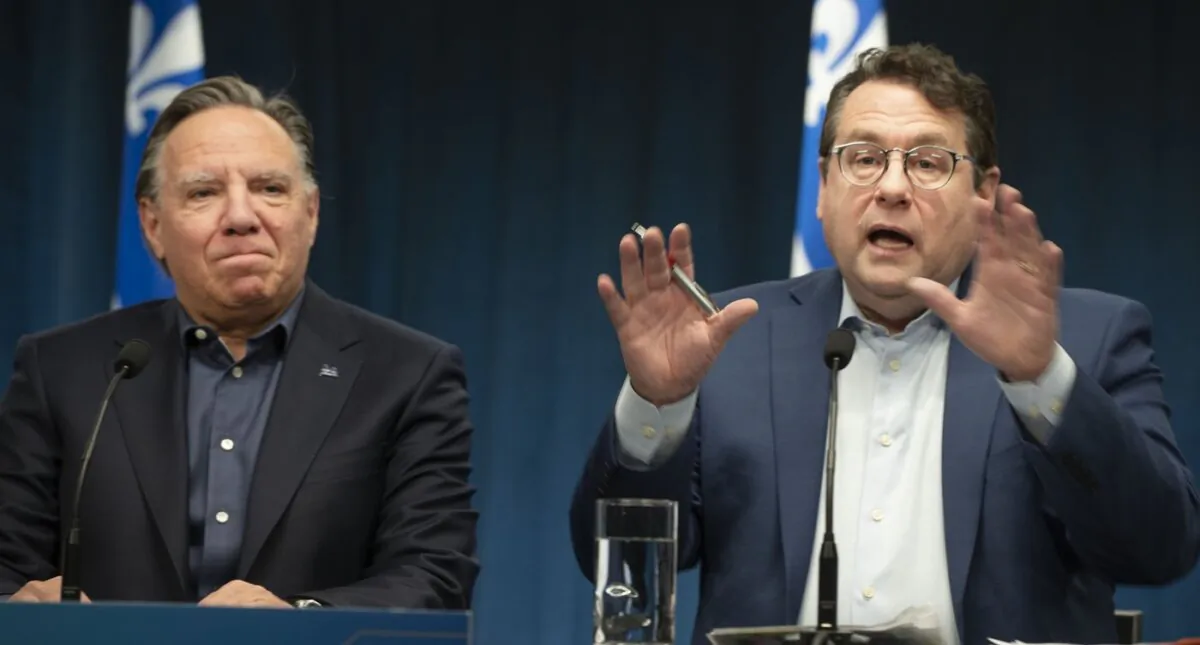 Bernard Drainville, Quebec Minister of Education speaks to the press alongside Quebec Premiere Francois Legault during a press conference in Montreal, on Feb. 18, 2024. (The Canadian Press/Peter McCabe)