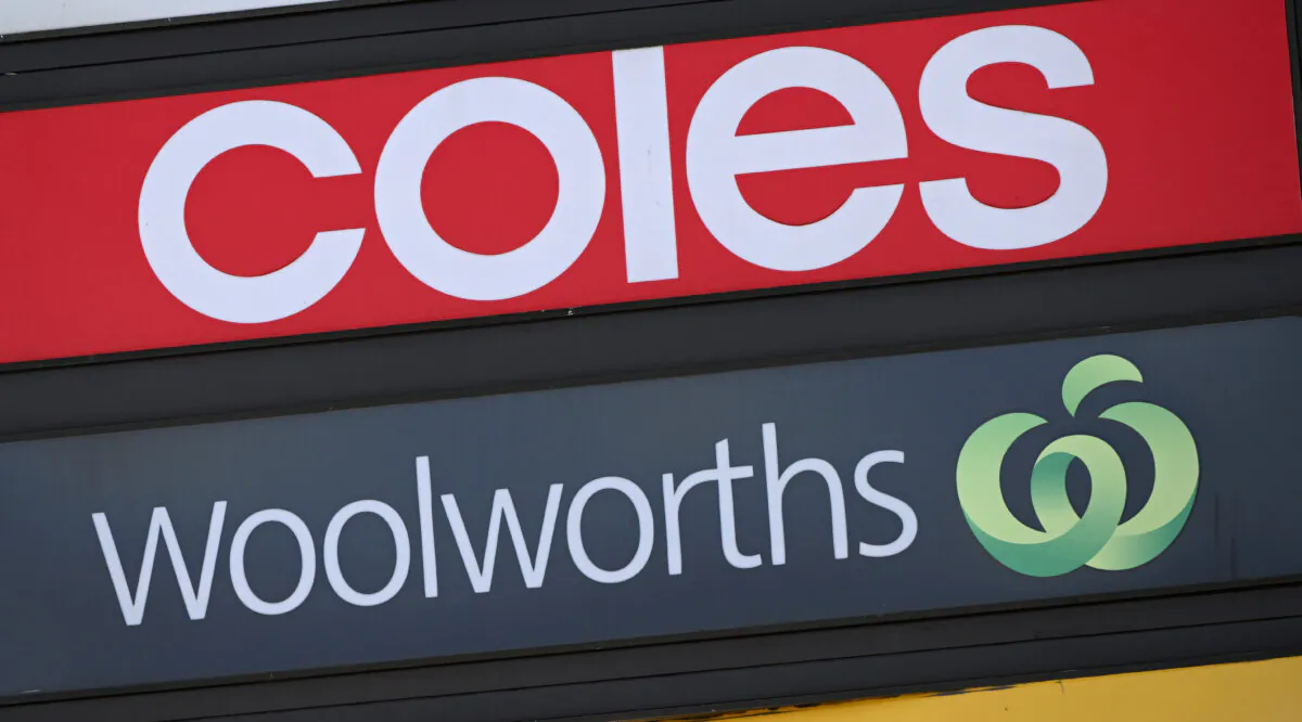 Woolworths and Coles Supermarket signage in Melbourne, Australia, on Feb. 21, 2024. (AAP Image/Joel Carrett) 