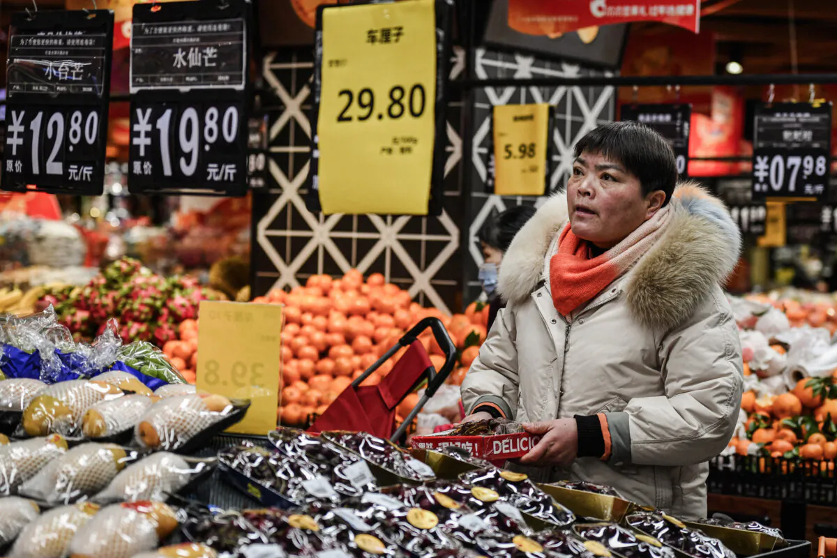 A customer shops for fruit and vegetables at a supermarket in Fuyang, Anhui Province, China, on Feb. 8, 2024. (STR/AFP via Getty Images)