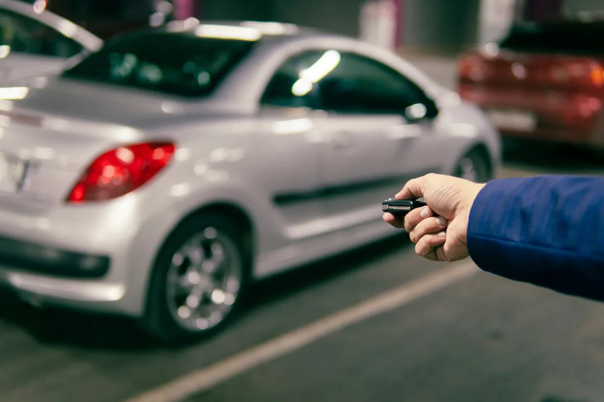 A man locks his car using a key fob, in a file photo. (Shutterstock/Melnikov Dmitriy)
