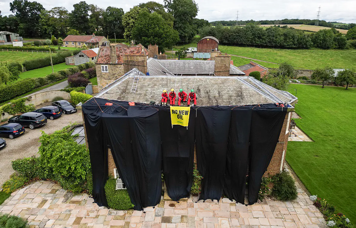 Greenpeace activists on the roof of Prime Minister Rishi Sunak's house in Richmond, North Yorkshire, on Aug. 3, 2023. (PA Media)