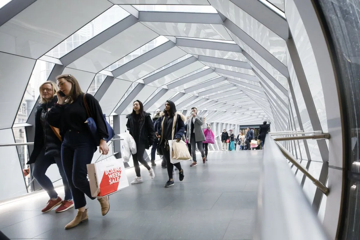 People walk in an overhead pedestrian crossing in Toronto on Dec. 26, 2019. (The Canadian Press/Cole Burston)