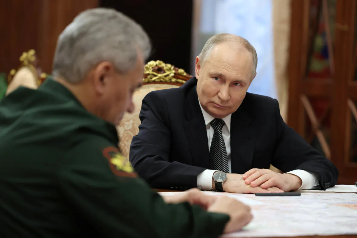 Russia's President Vladimir Putin listens to Defence Minister Sergei Shoigu during a meeting in Moscow, Russia, on Feb. 20, 2024. (Sputnik/Alexander Kazakov/Pool via Reuters)