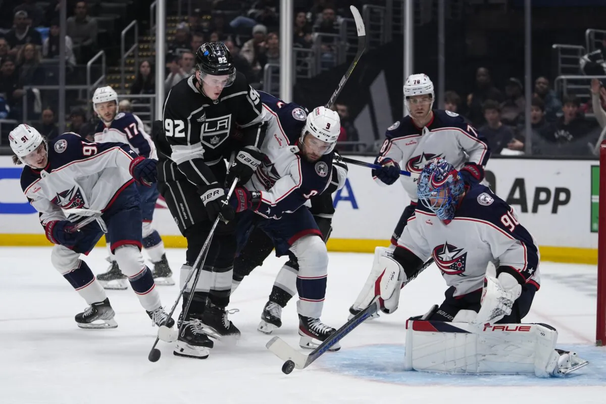 Los Angeles Kings defenseman Brandt Clarke (92) shoots against Columbus Blue Jackets goaltender Elvis Merzlikins (90) and Ivan Provorov (9) during the second period of an NHL hockey game in Los Angeles on Feb. 20, 2024. (Ryan Sun/AP Photo)