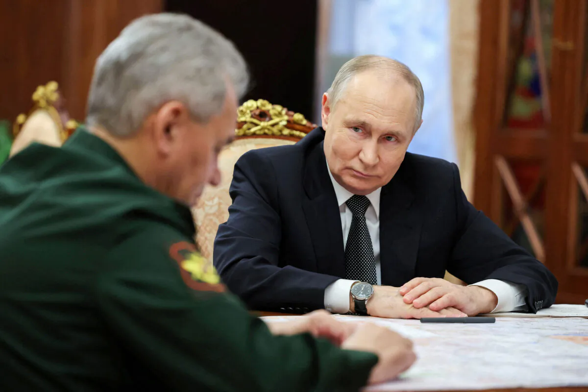 Russia's President Vladimir Putin listens to Defense Minister Sergei Shoigu during a meeting in Moscow on Feb. 20, 2024. (Sputnik/Alexander Kazakov/Pool via Reuters)