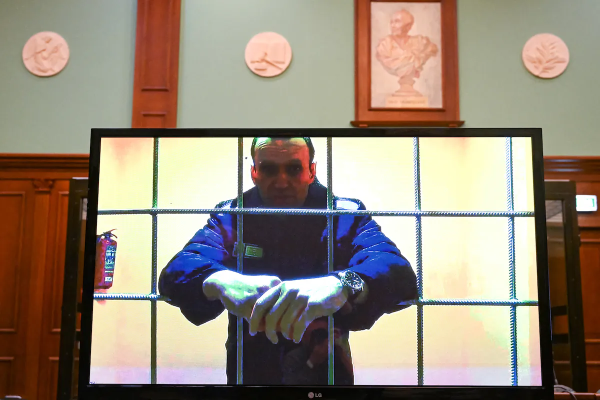 Opposition leader Alexei Navalny appears on a screen set up at a courtroom of the Moscow City Court via a video link from his prison colony during a hearing of an appeal against his nine-year prison sentence he was handed in March after being found guilty of embezzlement and contempt of court, in Moscow on May 17, 2022. (Kirill Kudryavtsev /AFP via Getty Images)