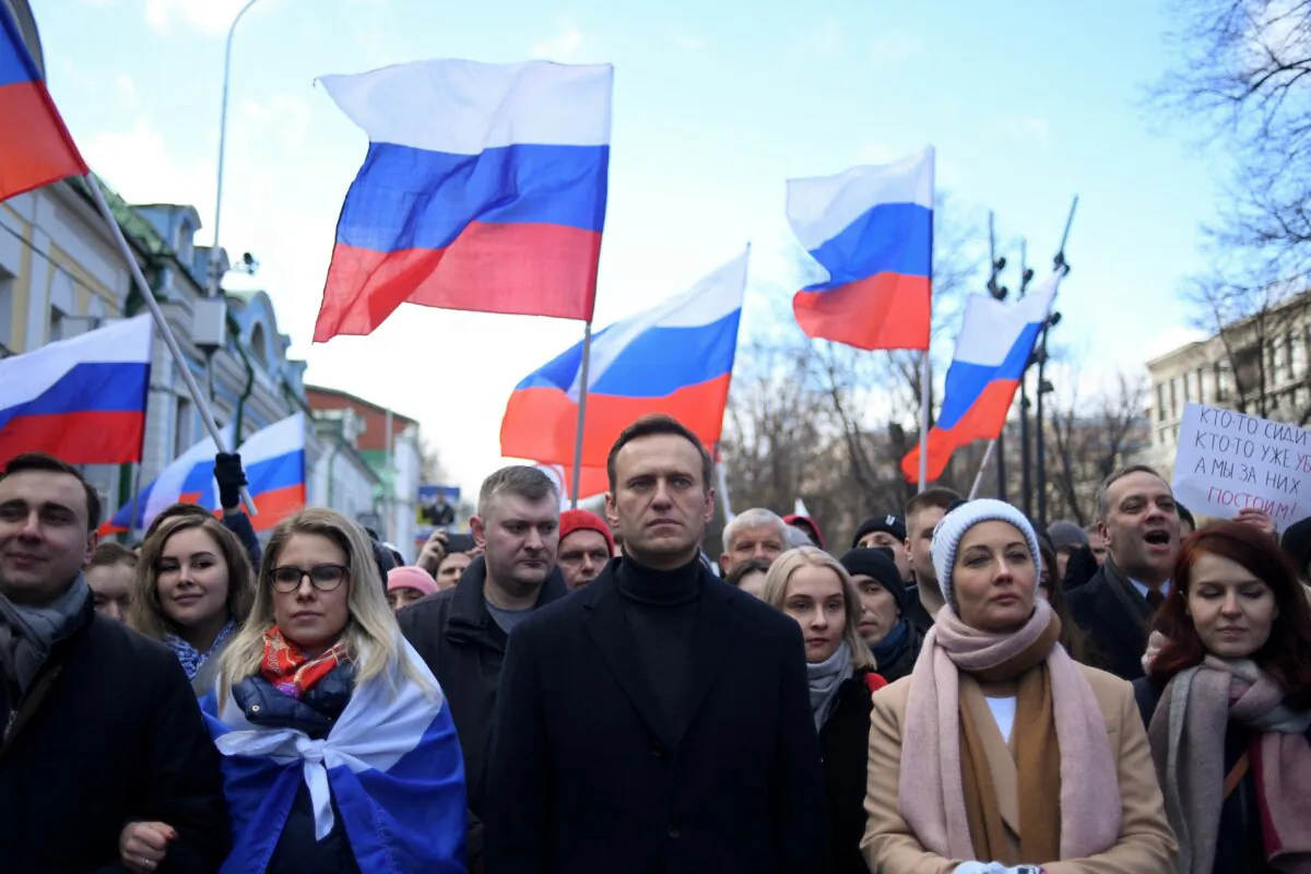Russian opposition leader Alexei Navalny, his wife Yulia, opposition politician Lyubov Sobol and other demonstrators march in memory of murdered Kremlin critic Boris Nemtsov in downtown Moscow on February 29, 2020. (Kirill Kudryavtsev/AFP via Getty Images)