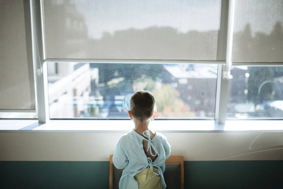 A toddler looks out the window from a children's hospital in an undated file photo. (Getty Images)