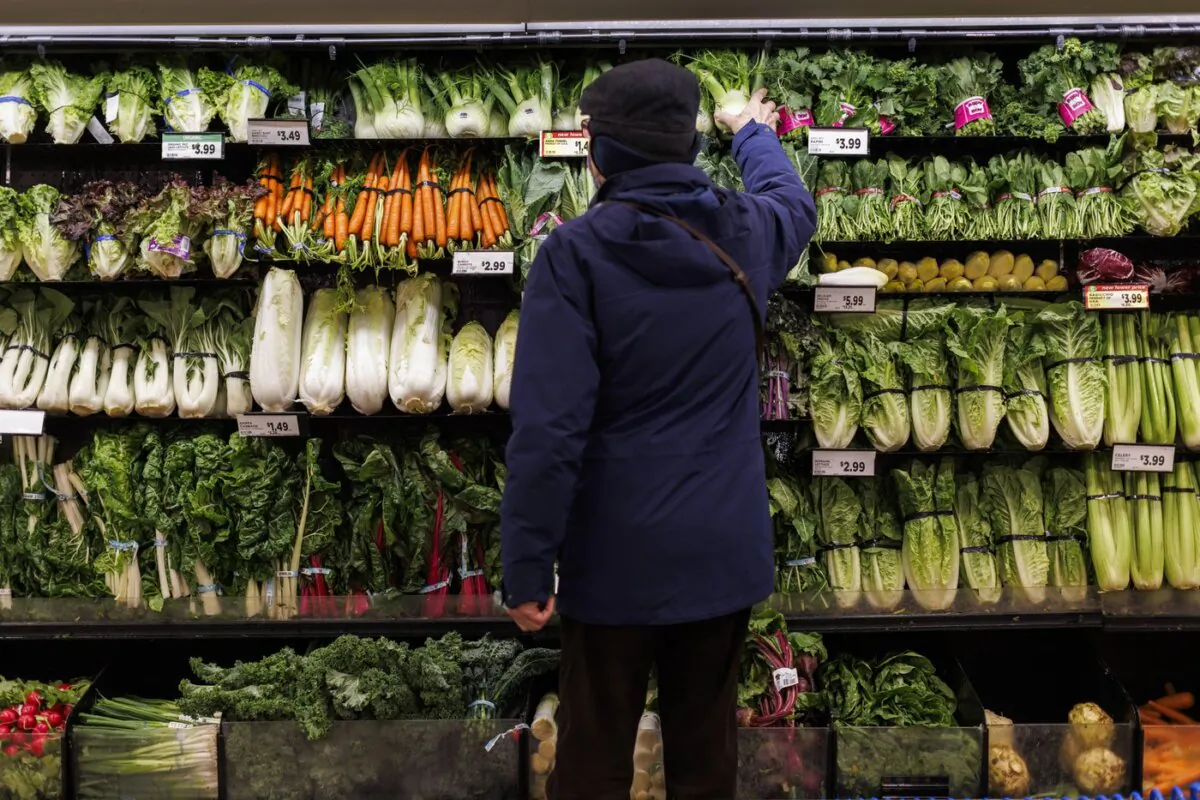 A customer shops for produce at a grocery store In Toronto on Feb. 2, 2024. (The Canadian Press/Cole Burston)