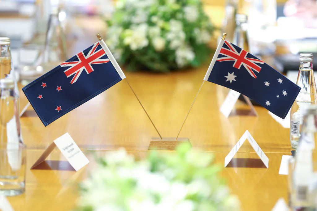 New Zealand and Australian flags sit on the table during a bilateral meeting at Parliament in Wellington, New Zealand, on July 26, 2023. (Hagen Hopkins/Getty Images)