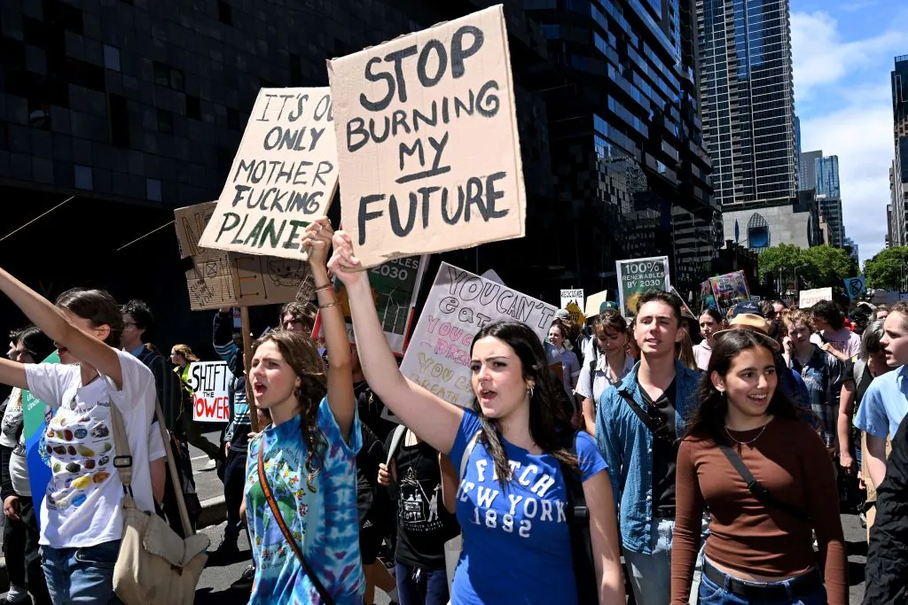 School students hold up placards as they march at a School Strike 4 Climate rally calling for climate change action in Melbourne, Australia, on Nov. 17, 2023. (William West/AFP via Getty Images)