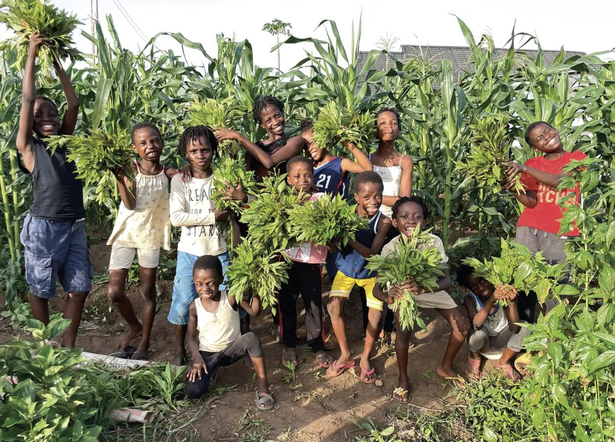 Students of Dream Catchers Academy tend to a plot of land where
they learn to
grow food. (Courtesy of Seyi Oluyole)