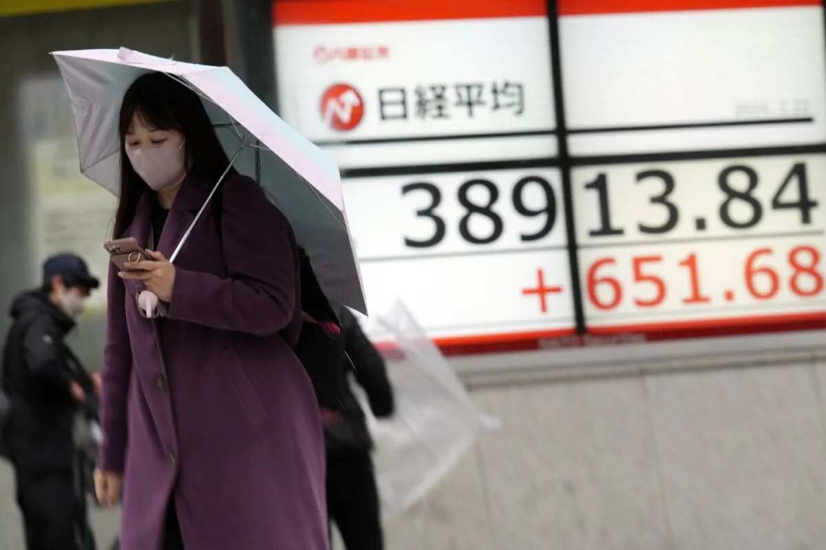 A person walks in front of an electronic stock board showing Japan's Nikkei 225 index at a securities firm in Tokyo on Feb. 22, 2024. (Eugene Hoshiko/AP Photo)
