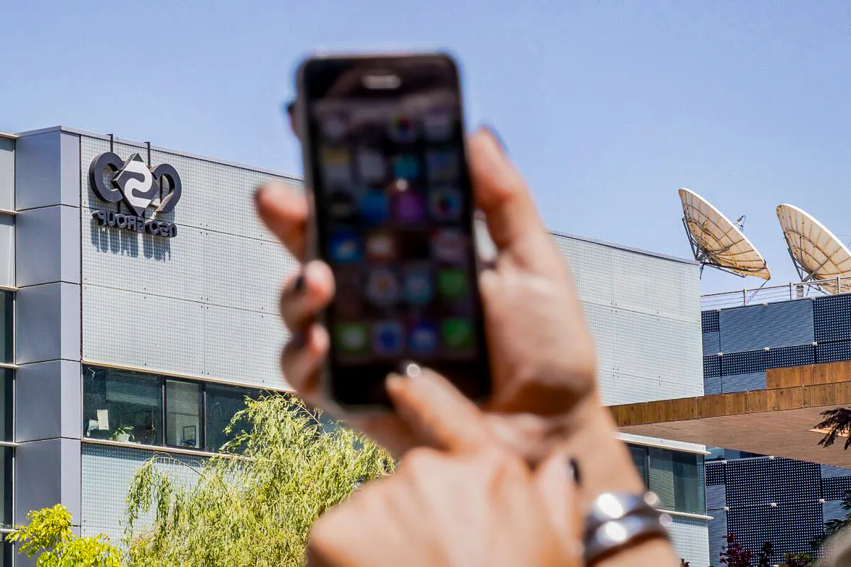 A woman uses her iPhone in a file photo. (Jack Guez/AFP via Getty Images)