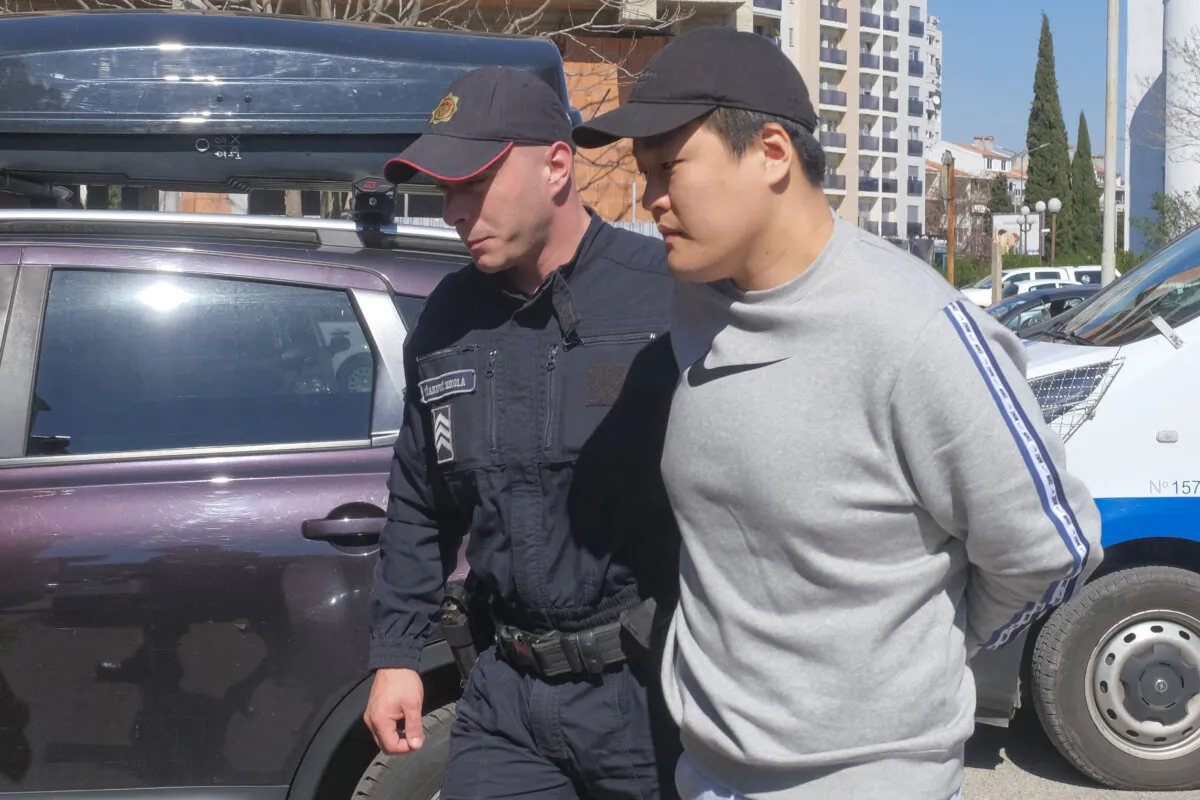 Montenegrin police officers escort South Korean citizen, Terraform Labs founder Do Kwon in Montenegro's capital Podgorica on March 24, 2023. (Risto Bozovic/AP Photo)