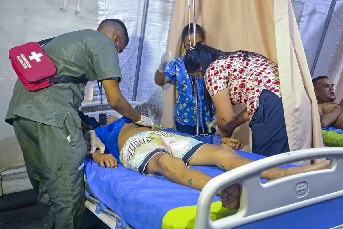 Yorvis Hernandez, a 34-year-old miner, gets medical attention at at tent set up next to a mine after it collapsed in La Paragua, Bolivar state, Venezuela, on Feb. 21, 2024. (Andrea Calma/AP Photo)