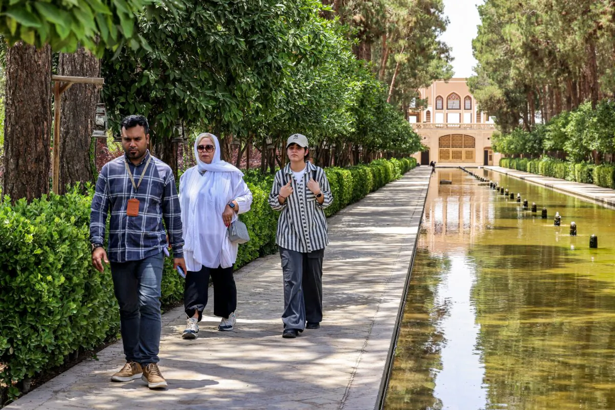 A guide leads tourists at the Dowlat Abad Garden in Iran's central city of Yazd on July 3, 2023. (Atta Kenare/AFP via Getty Images)