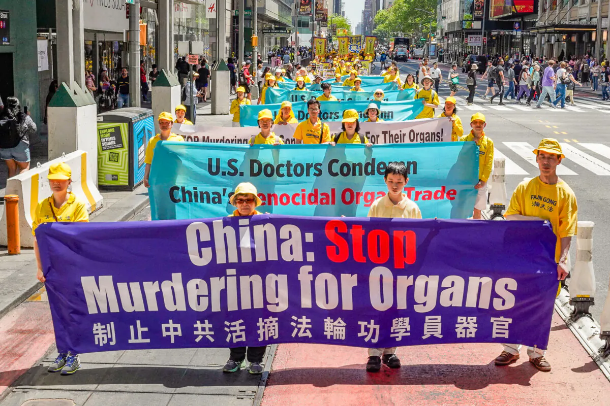 Falun Gong practitioners take part in a parade to bring about awareness of the Chinese Communist Party's persecution and forced organ harvesting of Falun Gong adherents in China, in Manhattan on May 12, 2023. (Larry Dye/The Epoch Times)