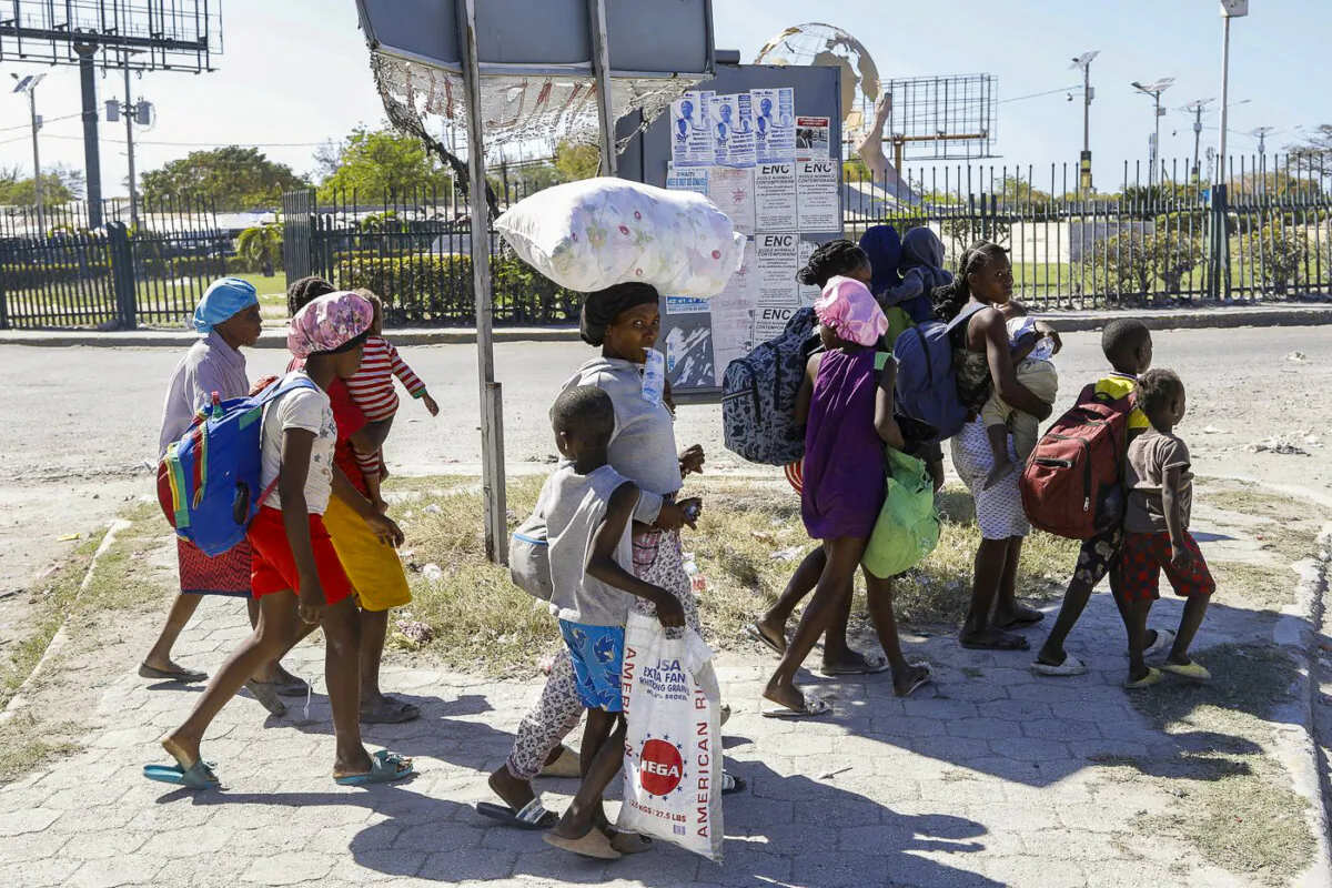 People flee their homes in Cite Soleil due to gang violence as they walk to a police station in Port-au-Prince, Haiti, on Feb. 12, 2024. (The Canadian Press/AP-Odelyn) 