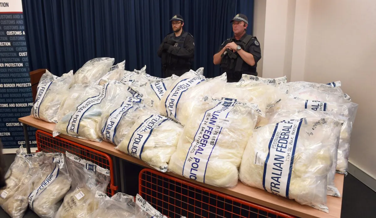 Australian Federal Police officers stands guard over some seized drugs in Sydney on Nov. 29, 2014. (WILLIAM WEST/AFP via Getty Images)