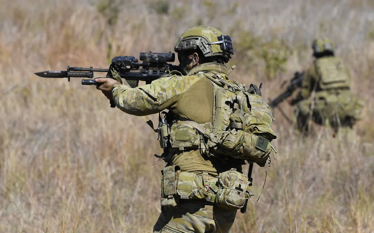 Soldiers from 1 RAR (Royal Australian Regiment) participate in a platoon live fire attack in Townsville, Australia, on Aug. 24, 2020. (Ian Hitchcock/Getty Images)