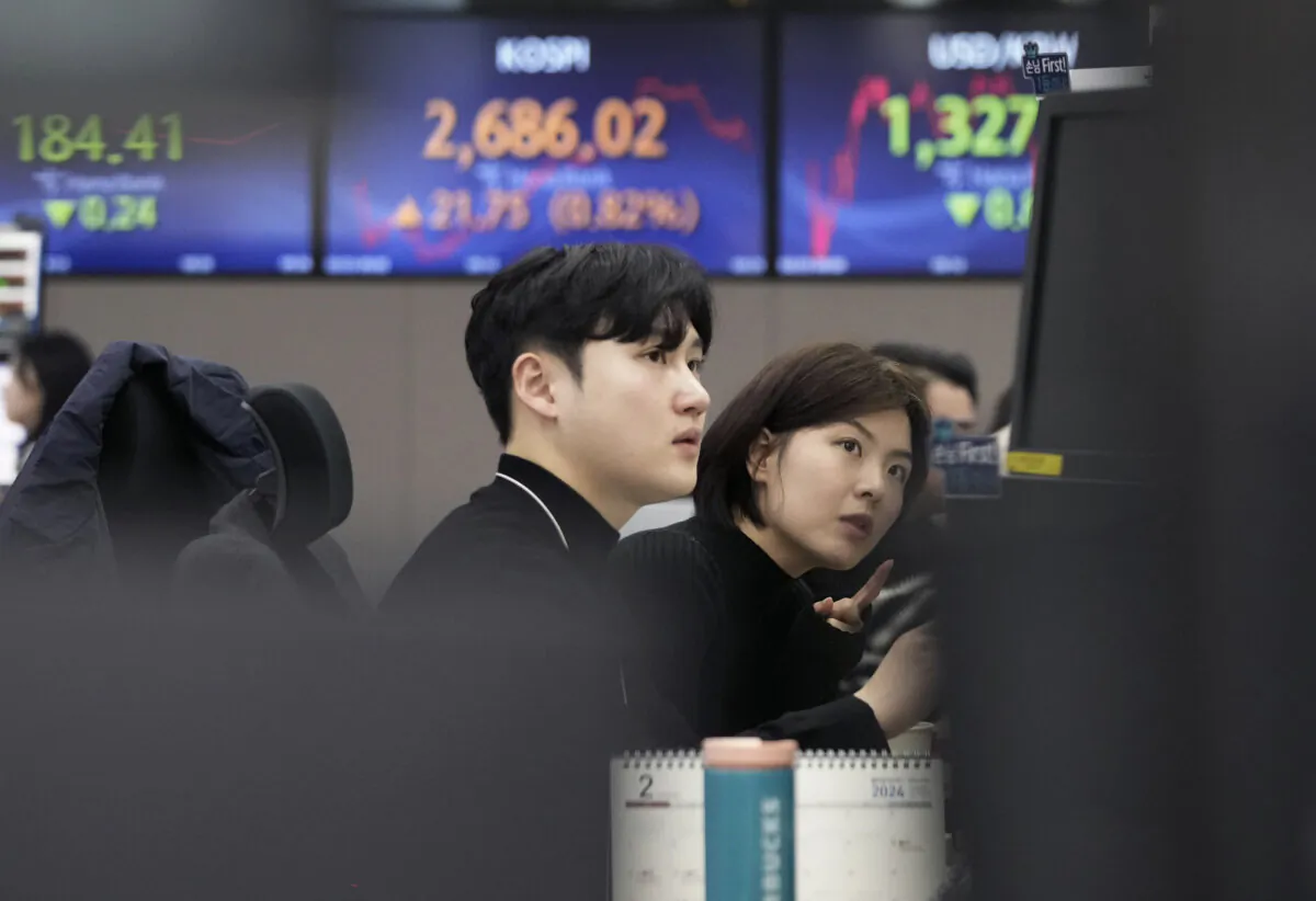 Currency traders watch monitors at the foreign exchange dealing room of the KEB Hana Bank headquarters in Seoul, South Korea, on Feb. 23, 2024. (Ahn Young-joon/AP Photo)