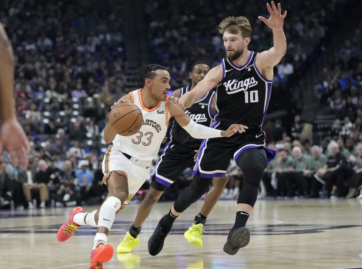 Tre Jones (33) of the San Antonio Spurs drives on Domantas Sabonis (10) of the Sacramento Kings in the first quarter in Sacramento, Calif., on Feb. 22, 2024. (Thearon W. Henderson/Getty Images)