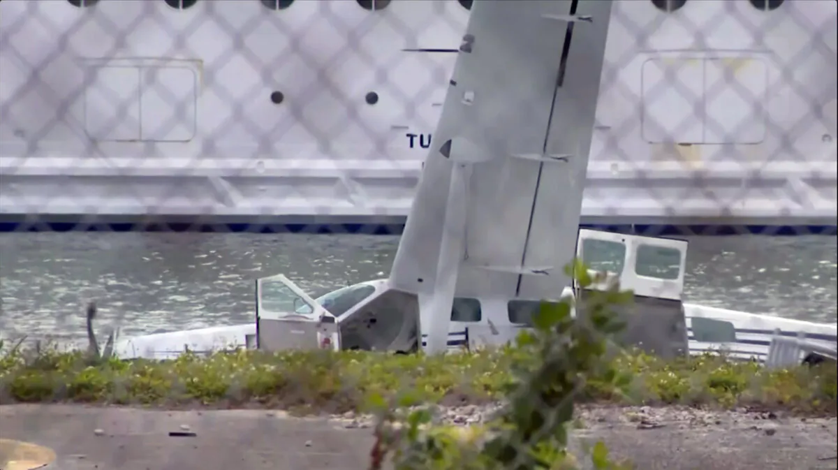 In this screen grab captured from WPLG-TV video, a plane is seen towed in Miami, Friday, Feb. 23 2024, after officials say the seaplane overturned while trying to land near PortMiami. Miami-Dade Fire Rescue says the aircraft came down in a channel between the port's cruise ship terminals and a causeway that connects Miami to Miami Beach. No serious injuries were reported. (WPLG-TV via AP)