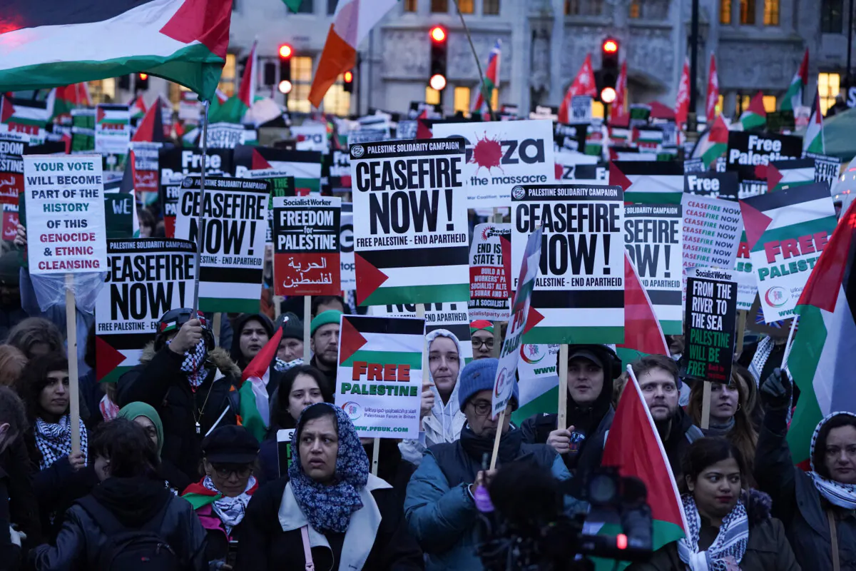 People take part in a Palestine Solidarity Campaign rally outside the Houses of Parliament in London, as MPs debate calls for a ceasefire in Gaza on Feb. 21, 2024. (Lucy North/PA Wire)