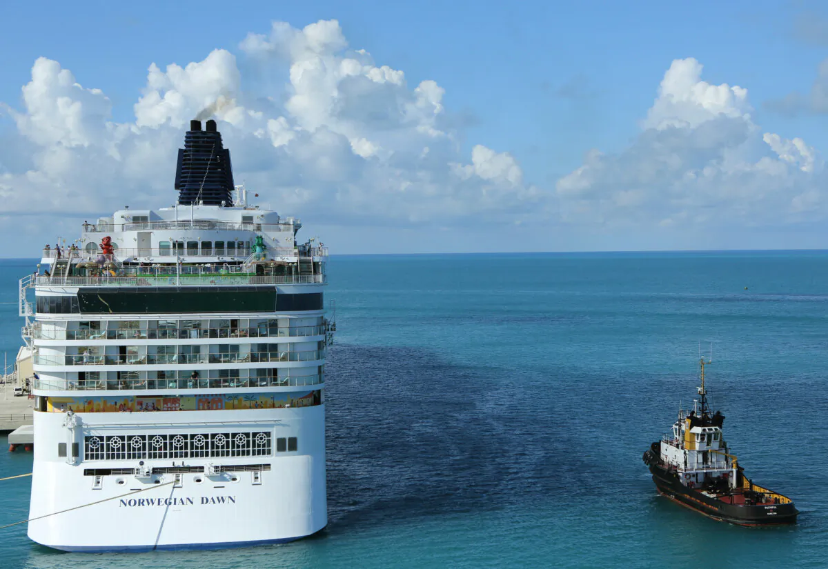 The cruise ship of the Norwegian Cruise Line 'Norwegian Dawn" (L) departs the Royal Naval Dockyard near the port of Hamilton, Bermuda, on July 16, 2013. (Gary Cameron/Reuters)