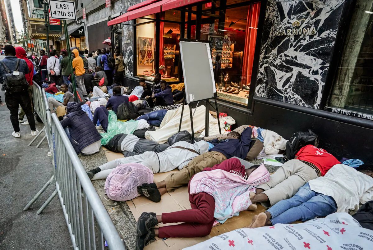Hundreds of illegal immigrants sleep outside as they wait for placement at the Roosevelt Hotel intake center in New York on Aug. 1, 2023. (Timothy A. Clary/AFP via Getty Images)