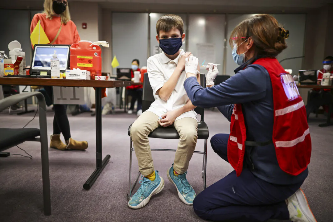 ANNANDALE, VIRGINIA - NOVEMBER 04: A child receives the Pfizer BioNTech COVID-19 vaccination at the Fairfax County Government Center on November 04, 2021 in Annandale, Virginia. The federal government approved the coronavirus vaccine for children between the ages of 5 and 11 this week. (Photo by Chip Somodevilla/Getty Images)
