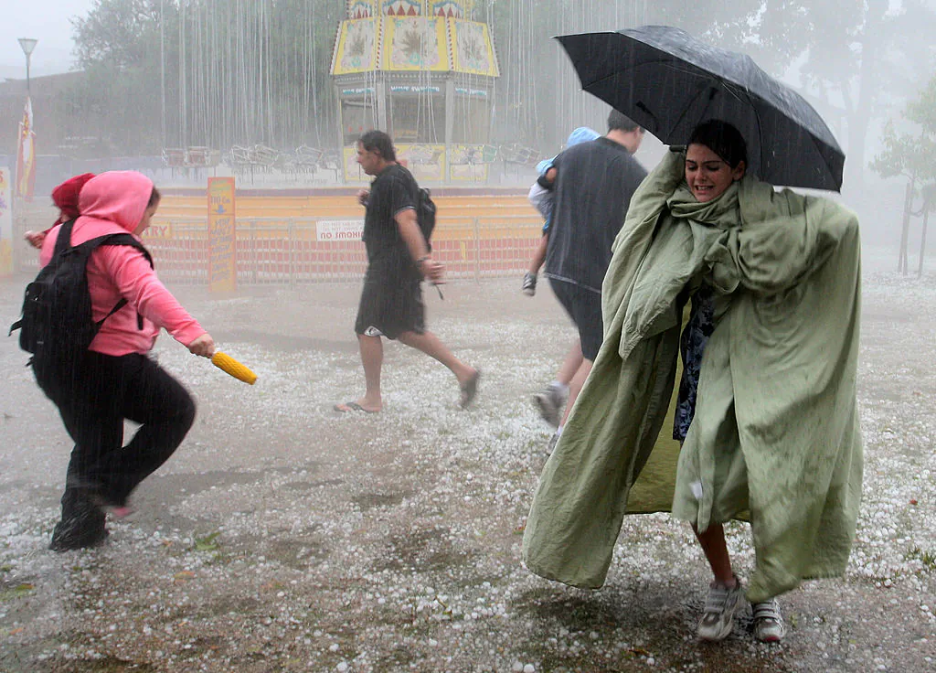 People look for cover from the hail storm in Melbourne, Australia, on March 6, 2010. (Photo by Lisa Maree Williams/Getty Images)