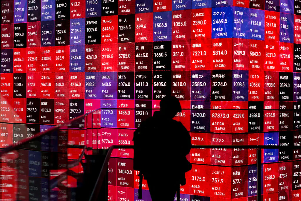 An electronic board displays stock prices of companies listed on the Tokyo Stock Exchange, along a street in Tokyo, on Feb. 26, 2024.  (Kazuhiro Nogi/AFP via Getty Images)
