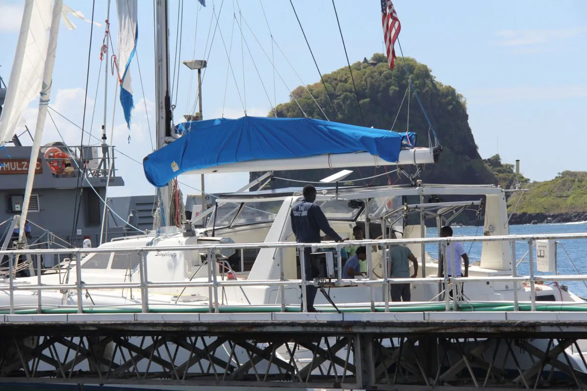 Investigators from Grenada and St. Vincent and the Grenadines stand aboard the yacht "Simplicity," now anchored at the St. Vincent and the Grenadines Coastguard Service Calliaqua Base, in Calliaqua, St. Vincent, on Feb. 23, 2024. (Kenton X. Chance/AP Photo)