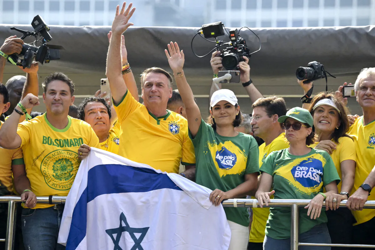 Former Brazilian President Jair Bolsonaro (center) greets supporters next to his wife, Michelle Bolsonaro, during a rally in São Paulo, Brazil, on Feb. 25, 2024. (Nelson Almeida/AFP via Getty Images)