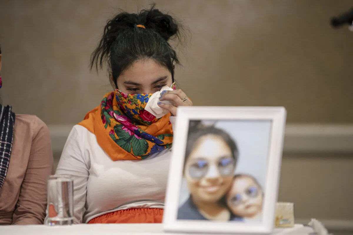 Kyla Frenchman, mother of Tanner Brass, wipes a tear at a joint media event organized by The Federation of Sovereign Indigenous Nations (FSIN) in Saskatoon, on Mar. 2, 2022. (The Canadian Press/Liam Richards)
